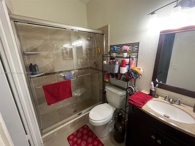 15235 SW 64th Ter Unit 9-35, Miami, FL 33193 - full bath featuring a textured wall, vanity, toilet, and a stall shower