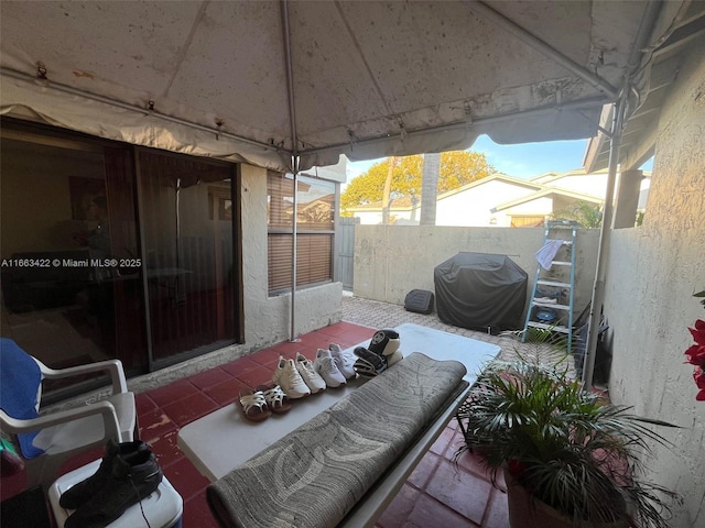 view of patio / terrace with a grill and fence