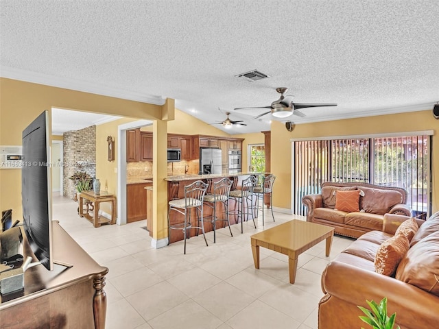 living room featuring lofted ceiling, a textured ceiling, light tile patterned floors, and crown molding