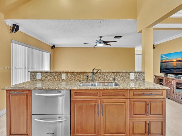 kitchen featuring a textured ceiling, ceiling fan, crown molding, and sink