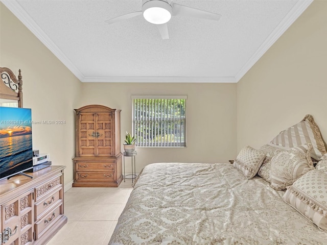 bedroom with a textured ceiling, light tile patterned floors, ornamental molding, and ceiling fan