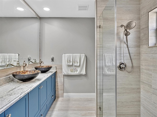 bathroom featuring vanity, hardwood / wood-style floors, and a shower with door