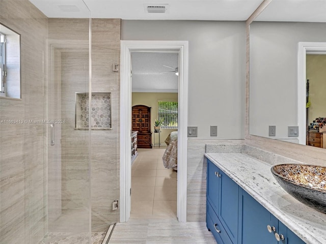 bathroom featuring tile walls, tile patterned flooring, walk in shower, and vanity