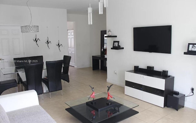 tiled living room with a chandelier