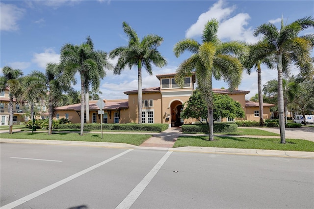 mediterranean / spanish house with a front yard