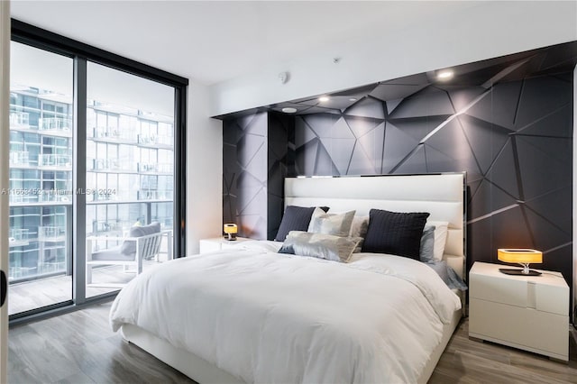 bedroom featuring access to exterior and hardwood / wood-style flooring