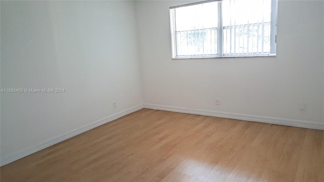 empty room with light hardwood / wood-style flooring