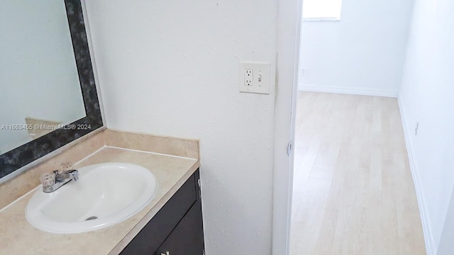 bathroom with vanity and wood-type flooring