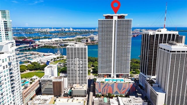 birds eye view of property featuring a water view and a city view