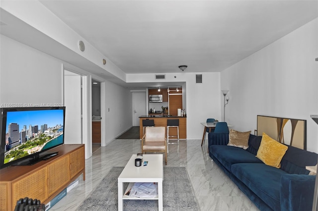 living area with marble finish floor and visible vents