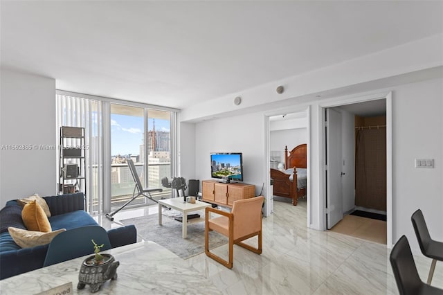 living room featuring expansive windows and marble finish floor