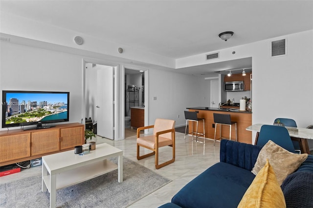 living area with marble finish floor and visible vents