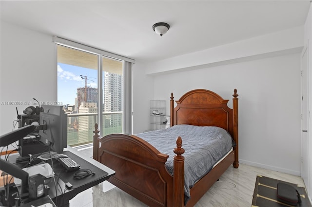 bedroom with baseboards, access to outside, and floor to ceiling windows