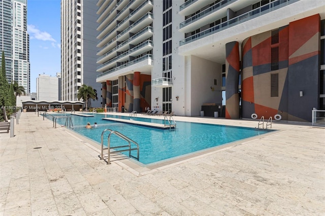 pool with a view of city and a patio