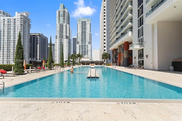 community pool featuring a view of city and a patio