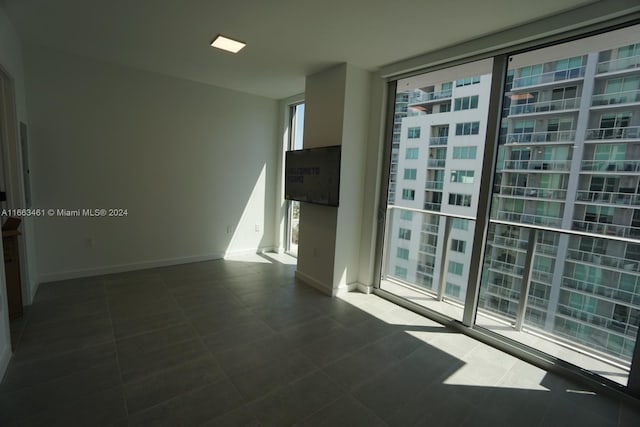 unfurnished room with floor to ceiling windows and a healthy amount of sunlight