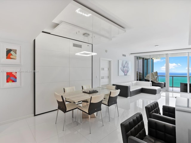 tiled dining space with a wall of windows and a water view