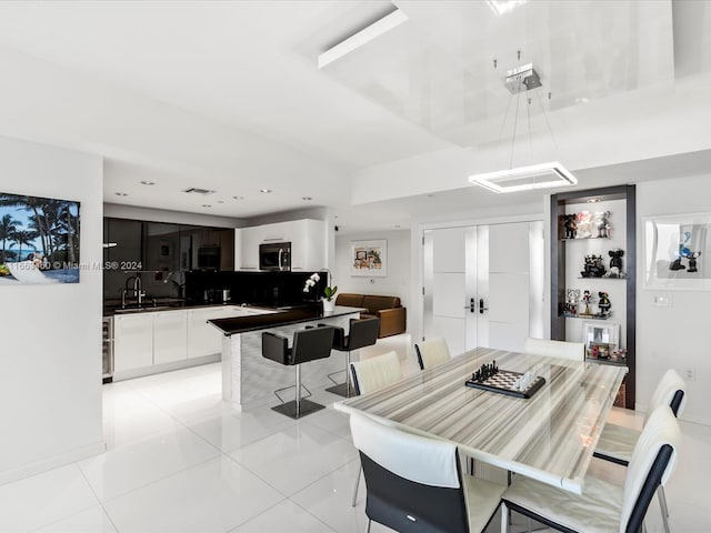 dining room with french doors, wine cooler, light tile patterned floors, and sink