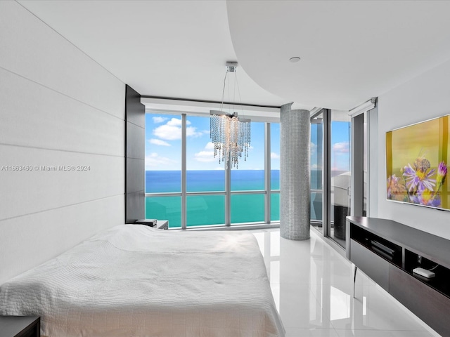 tiled bedroom with an inviting chandelier, a water view, multiple windows, and a wall of windows