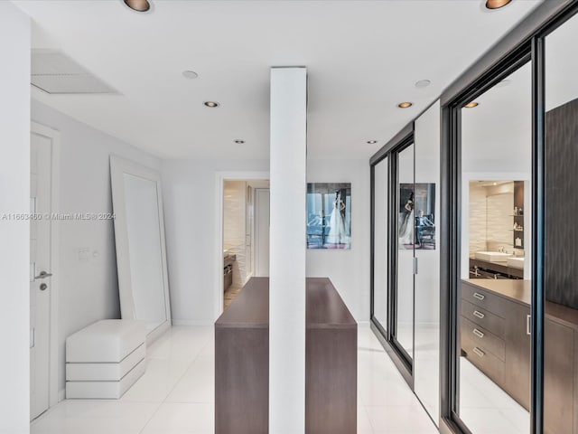 hall featuring light tile patterned floors