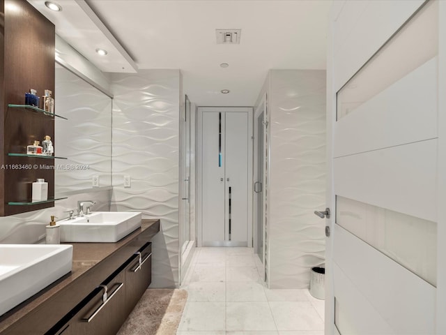 bathroom with tile walls, tile patterned floors, and vanity