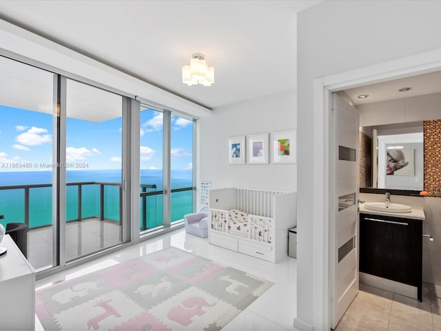 interior space with tile patterned flooring, a water view, and vanity