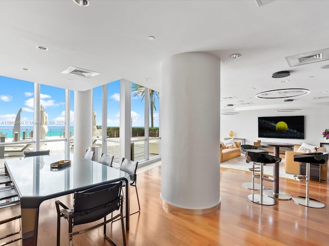 dining area featuring floor to ceiling windows and light hardwood / wood-style floors