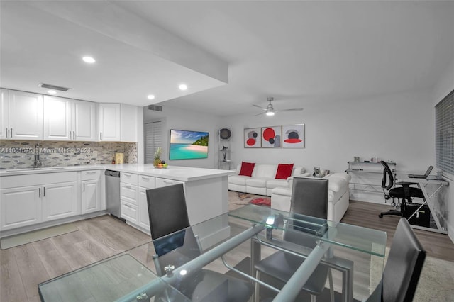 interior space with sink, ceiling fan, and light wood-type flooring