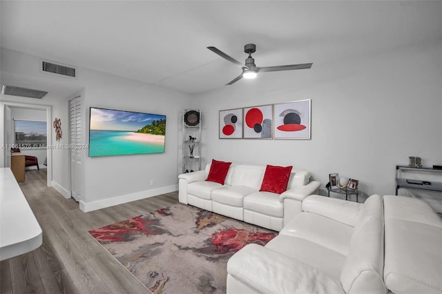 living room with ceiling fan and light wood-type flooring