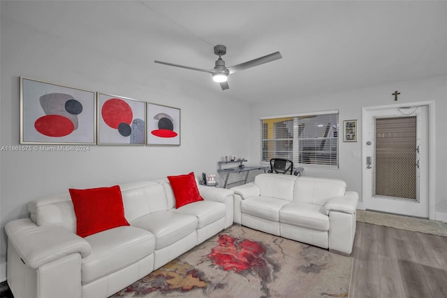 living room featuring hardwood / wood-style floors and ceiling fan