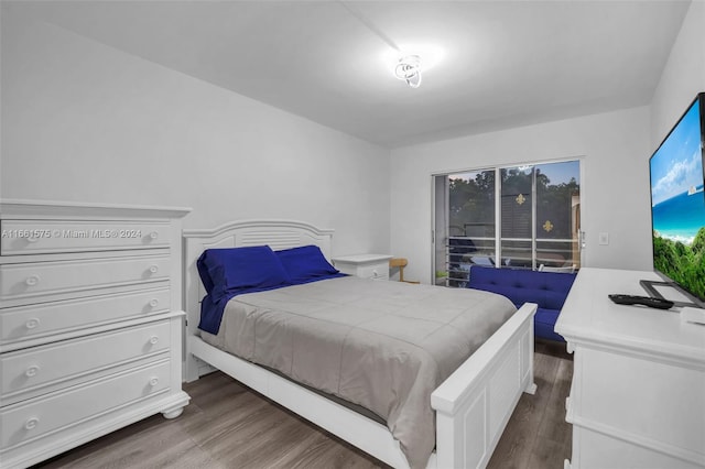 bedroom with dark hardwood / wood-style flooring