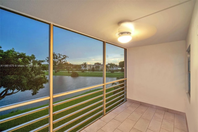 unfurnished sunroom featuring a water view