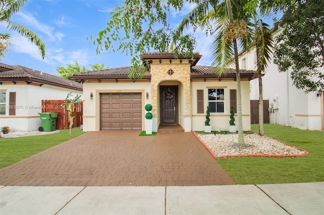 mediterranean / spanish-style home with a front yard and a garage