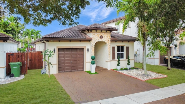 mediterranean / spanish-style home with a garage and a front yard