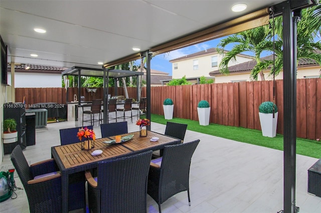 view of patio with an outdoor bar