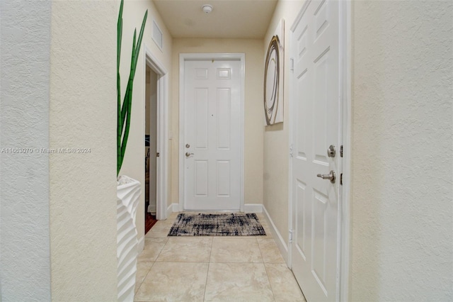 doorway to outside featuring light tile patterned floors