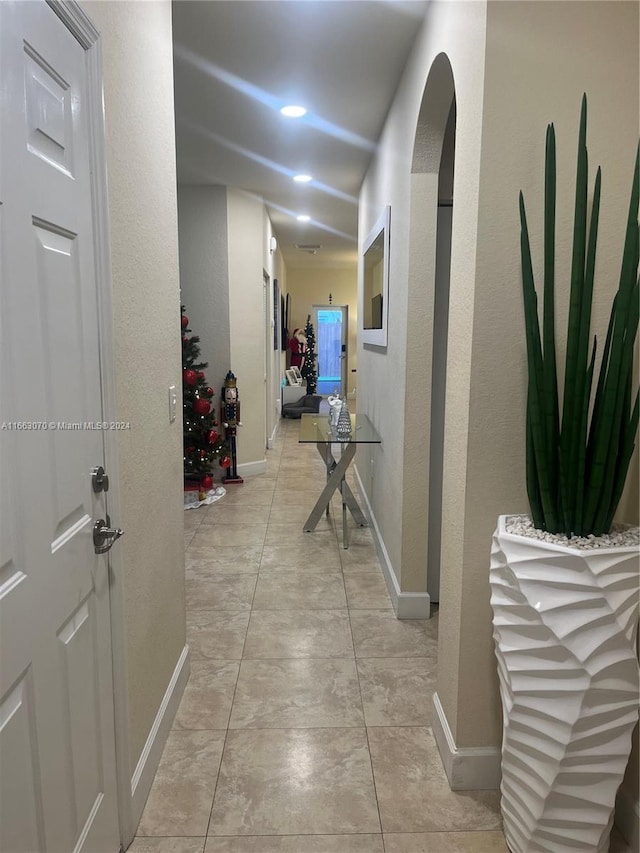 corridor featuring light tile patterned floors