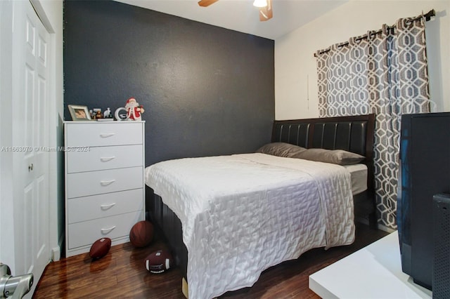 bedroom with ceiling fan and dark wood-type flooring