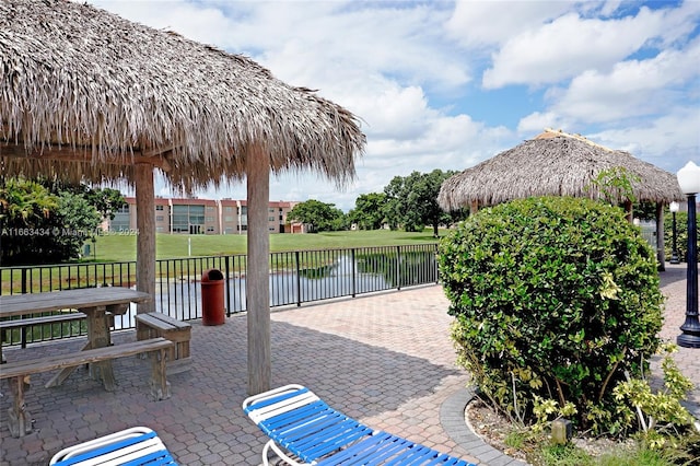 view of patio featuring a gazebo and a water view