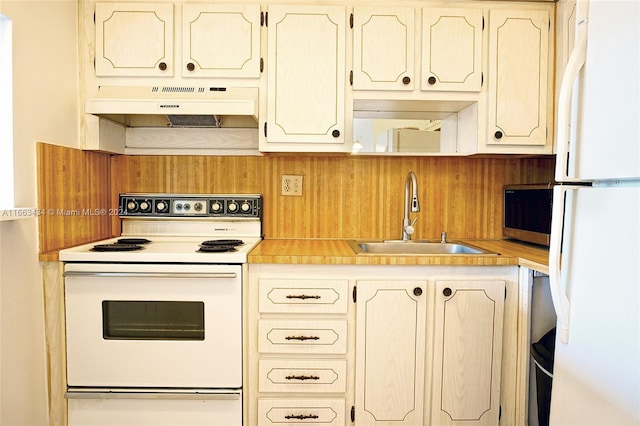 kitchen featuring white appliances and sink