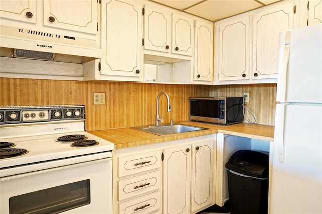 kitchen featuring white appliances, extractor fan, and sink