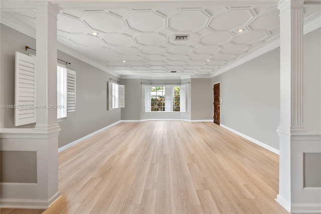 unfurnished living room with ornate columns and crown molding
