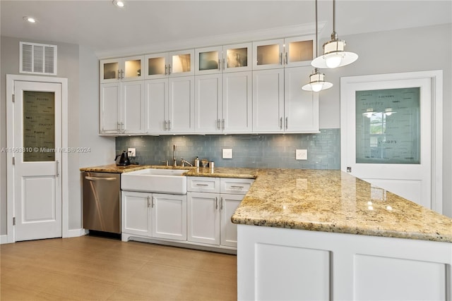 kitchen featuring stainless steel dishwasher, a sink, visible vents, and white cabinets