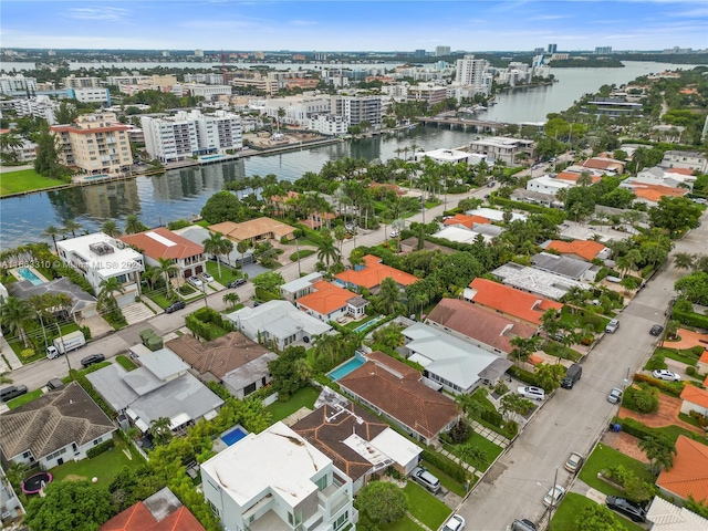 birds eye view of property with a water view and a city view