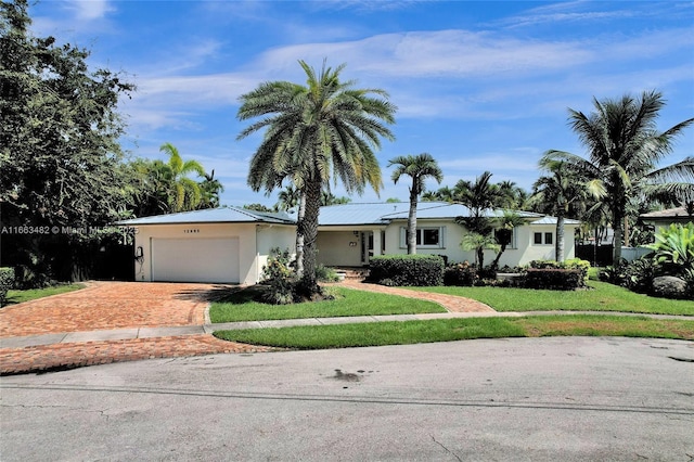 single story home with a front lawn and a garage