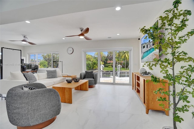 living room with ceiling fan and a healthy amount of sunlight