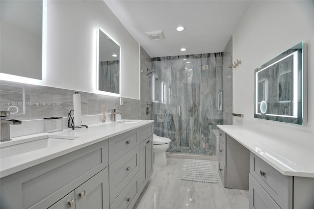 bathroom with walk in shower, vanity, tile walls, and toilet