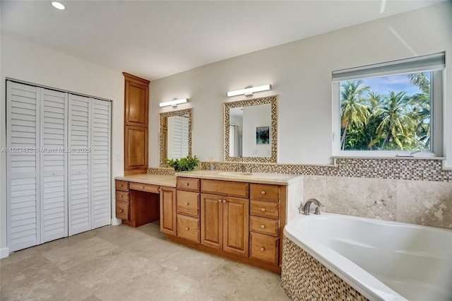 bathroom with vanity and a relaxing tiled tub