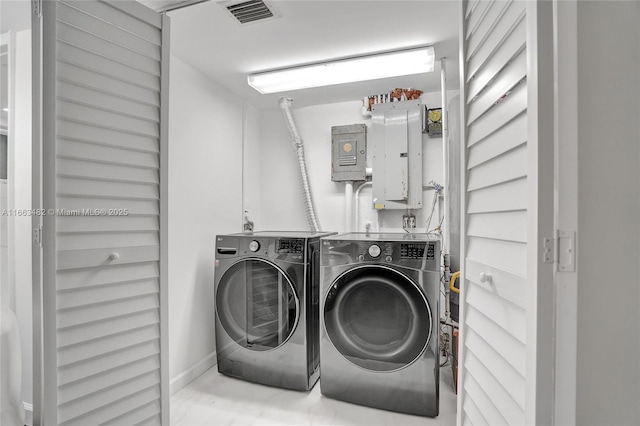 washroom with electric panel and washing machine and clothes dryer