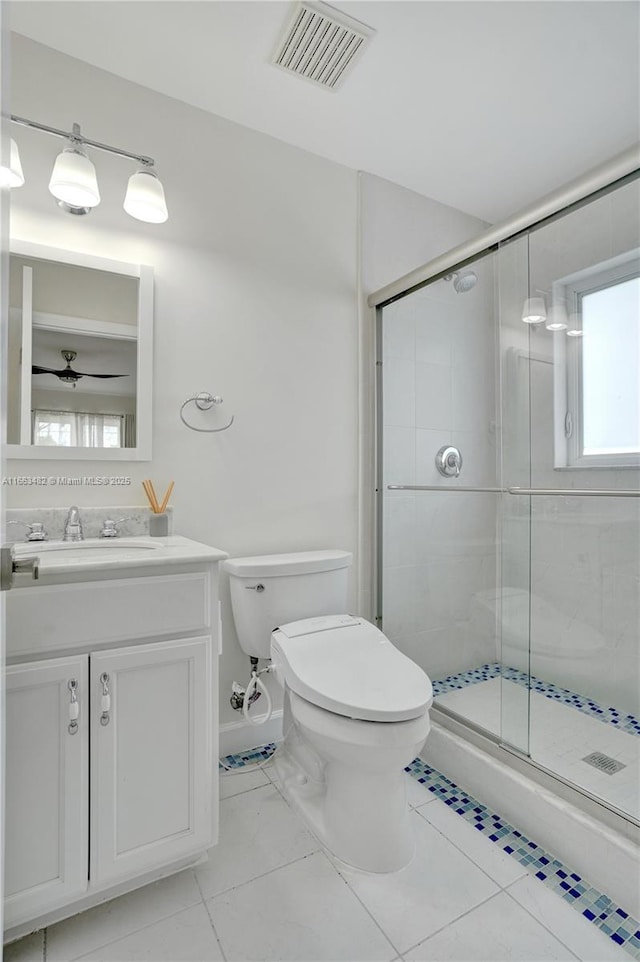 bathroom with vanity, toilet, and a shower with shower door